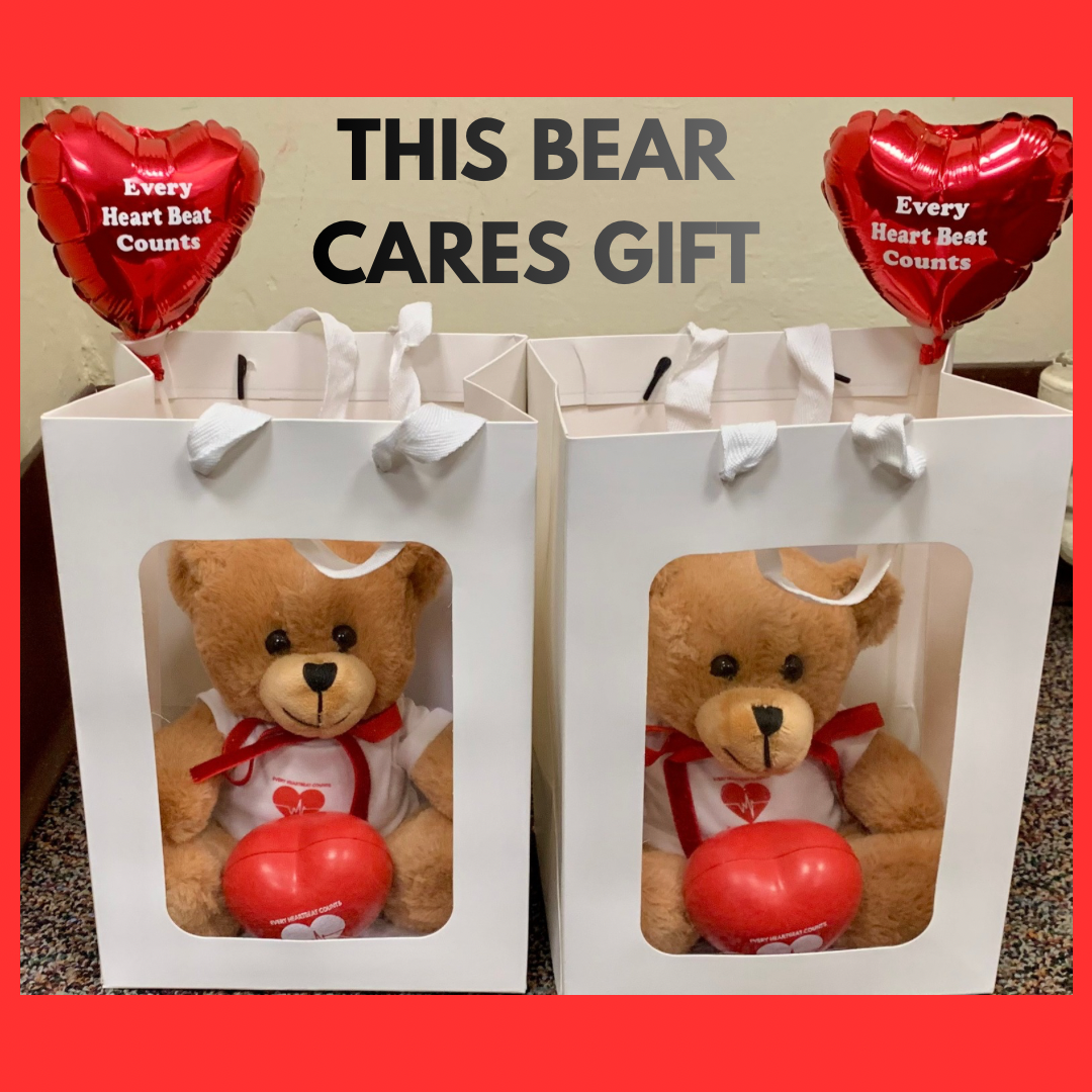 Two teddy bears holding heart-shaped balloons in gift boxes.