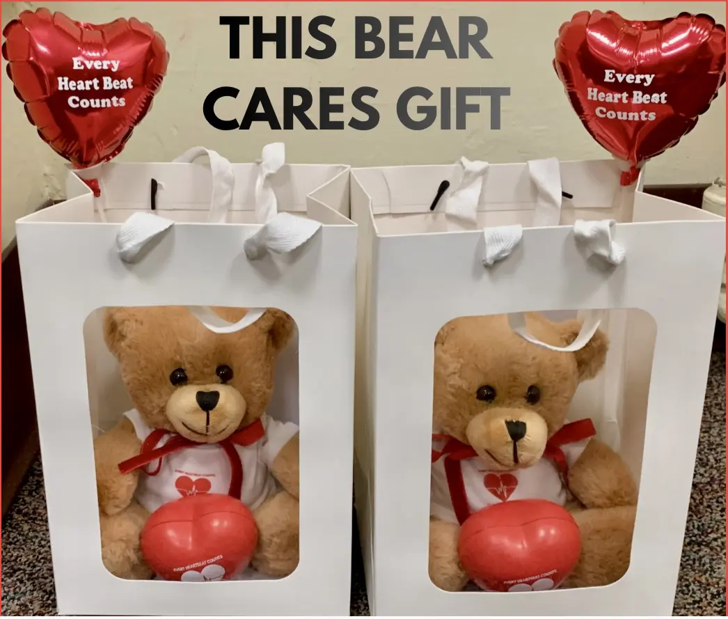 Two teddy bears holding heart-shaped balloons in gift boxes.