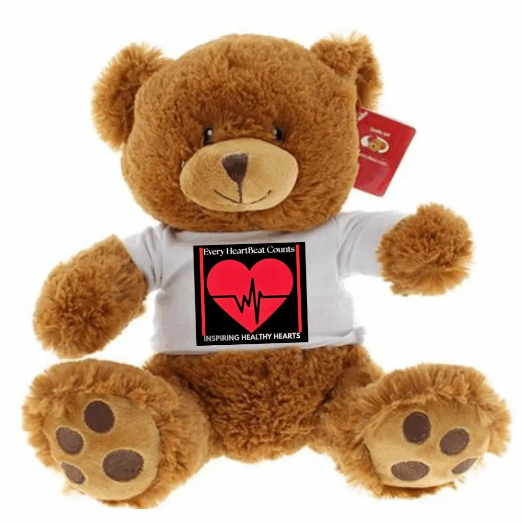 A brown teddy bear wearing a white shirt with a heart and heartbeat design.
