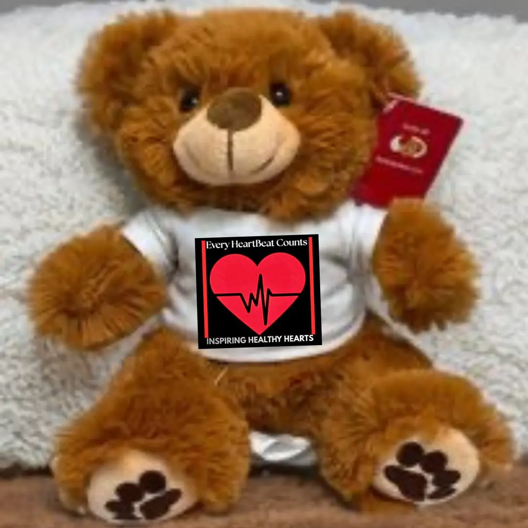 A teddy bear holding a heart-themed sign about love and life.
