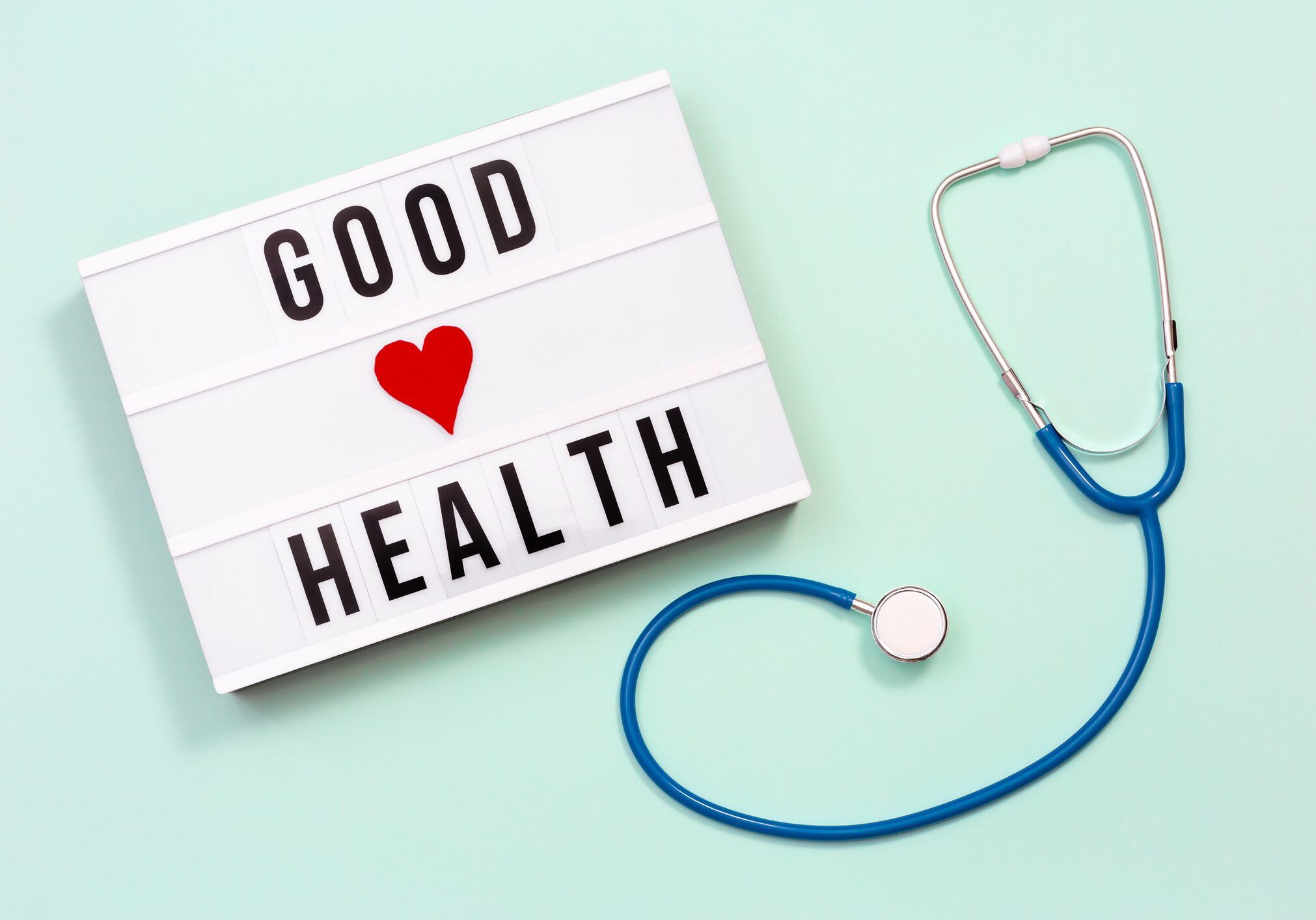 Lightbox sign saying 'GOOD HEALTH' with a stethoscope beside it.